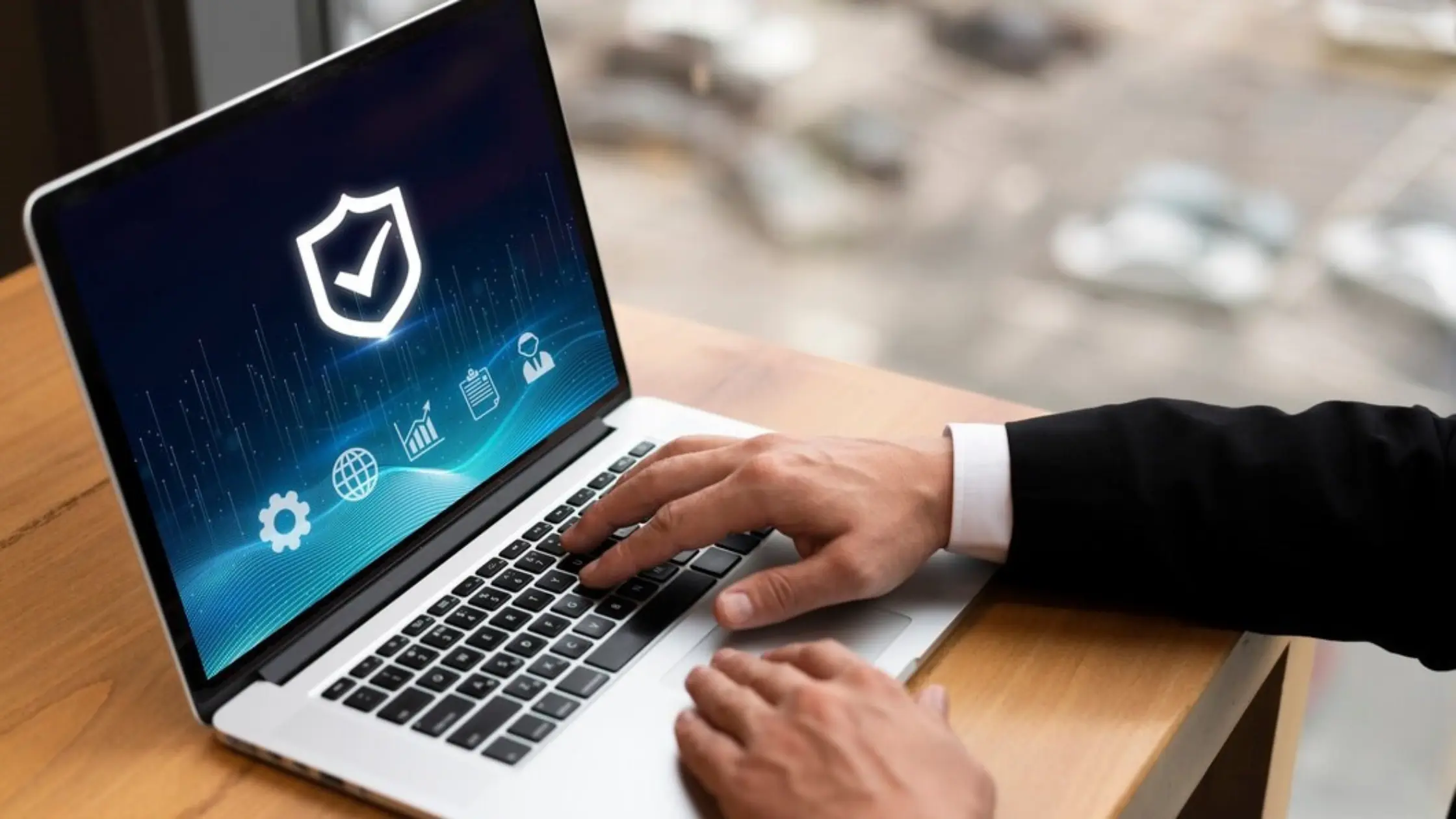A hand on a laptop with screen showing safety icon ensuring chargeback protection for high risk merchants.